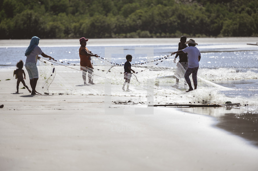 family with a fishing net on a beach 