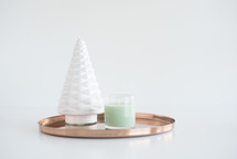 copper tray, mint candle, and white tree figurine 