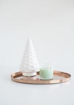 white tree figurine, mint candle, and gold tray 