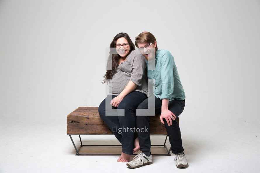 Couple sitting on a love-seat.