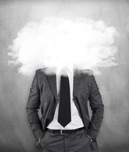 businessman on gray background with head in the clouds 