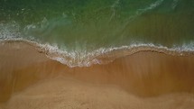 Aerial drone cinematic looking down waves crashing beachfront Hoosegor Capbreton France Europe