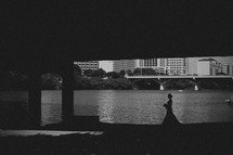 Bride walking under a bridge