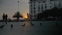 Children and Pigeons on City Square