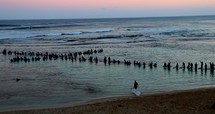 Christian Surfers make a cross in ocean 