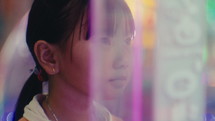 Little girl is playing games at the amusement park
