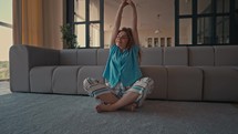 Woman stretching in her living room.