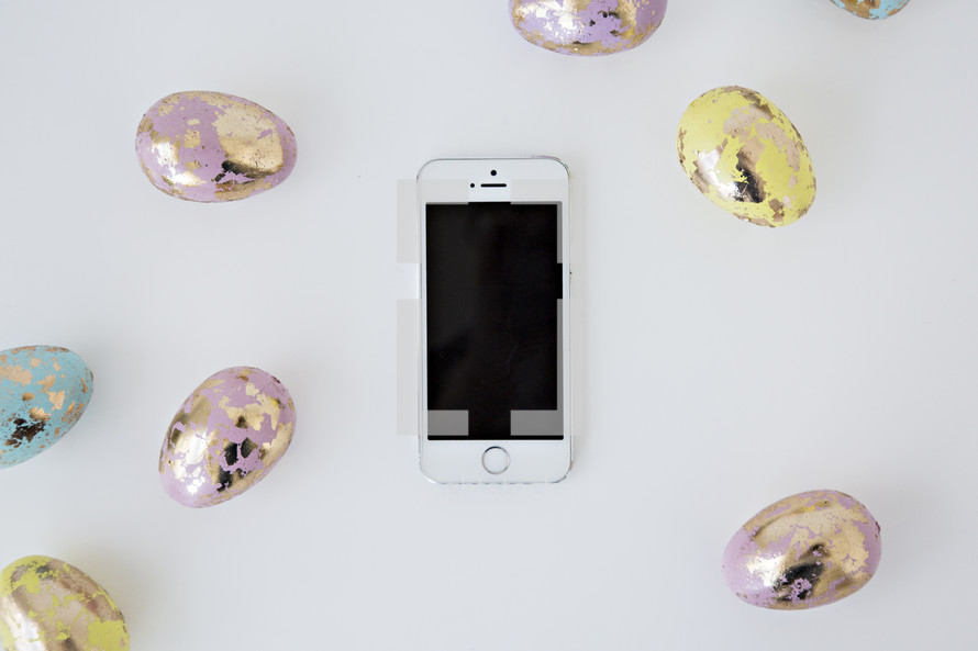 pastel gold speckled Easter eggs and cellphone 
