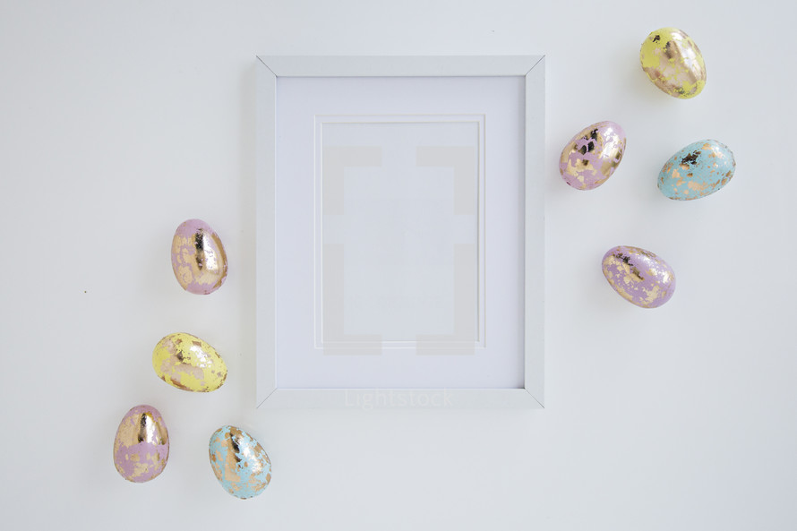 pastel gold speckled Easter eggs and blank frame 