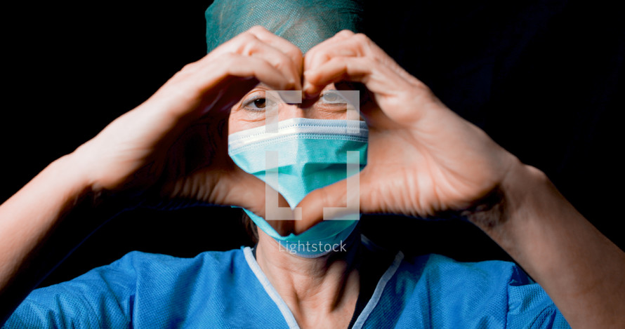 woman doctor making heart symbol with hands