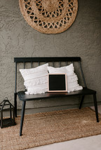 throw pillows and letter board on a bench 