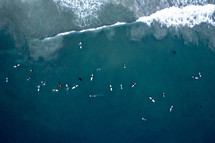 aerial view over surfers in the ocean 