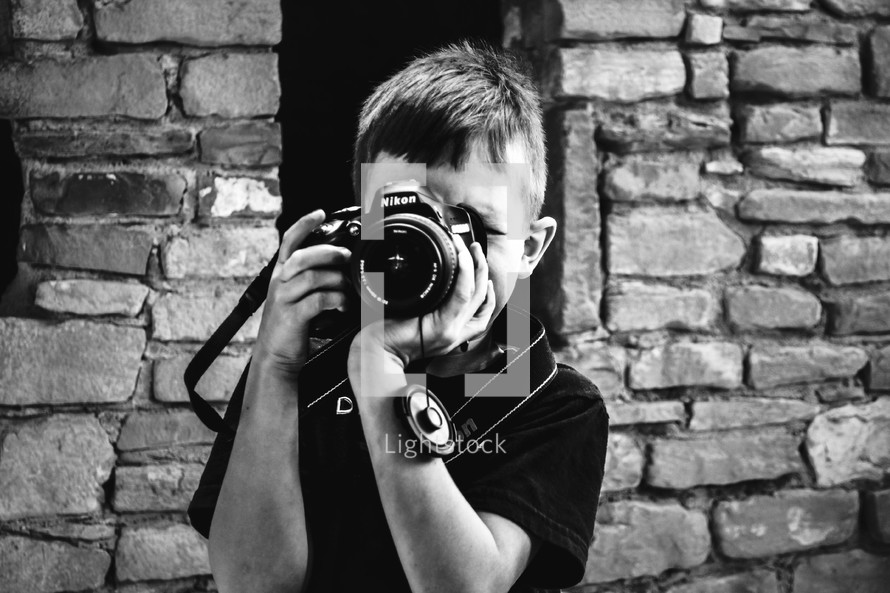 a child holding a camera 