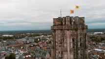 St. Rumbold's Cathedral Tower revealing Mechelen Flemish Flags - Aerial Crane up