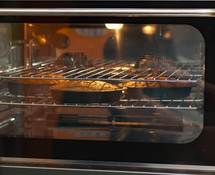 Three carrot cakes in the oven, ambient light.