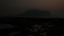 Sunrise Time Lapse of Volcanic Crater Along Coast In Jeju Island