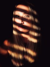 sunlight and shadows on a woman's face 