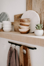 wooden bowls on a  floating shelf 
