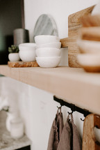 marble cutting board and bowls on a wood shelf 