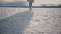 Young woman walking around salt flats during daytime
