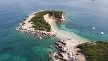 Ksamil twin islands, Pristine white sand beach surrounded by Turquoise Water, Albania - Aerial Orbiting