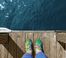 Feet at the end of a dock.