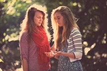 mother and daughter praying together outdoors 