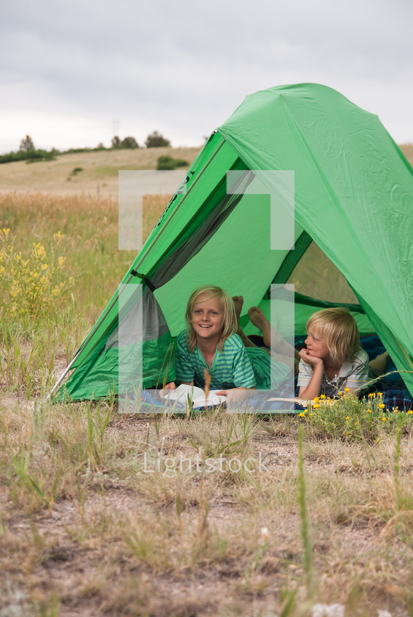 children in a tent outdoors 