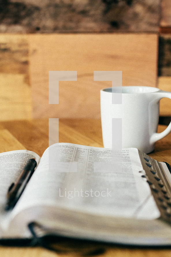An open Bible and coffee cup.