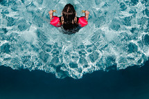 a girl swimming in a pool 