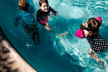 children playing in a pool 