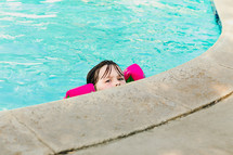 girl child at the edge of a pool 