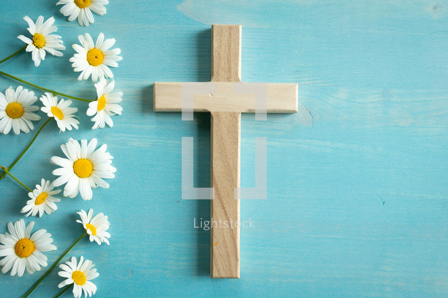 wooden cross and white daisies 