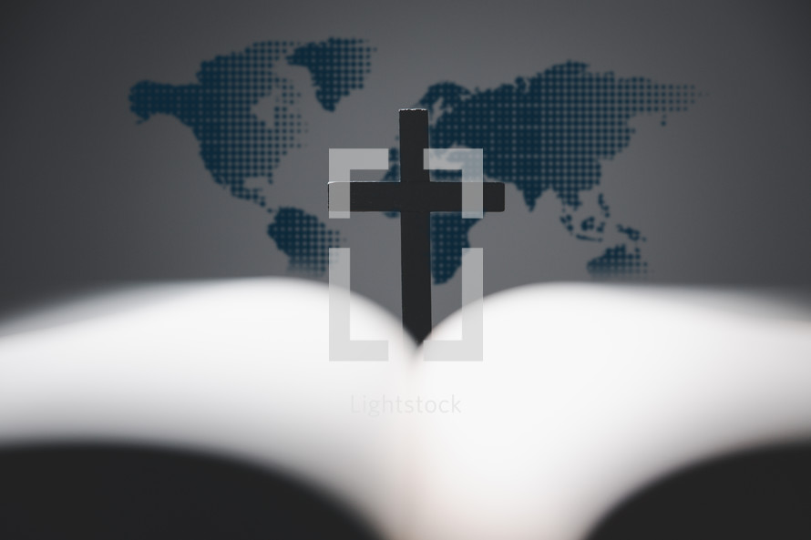 Cross and Bible in front of map of the world