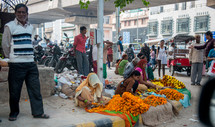 women selling flowers on a street corner in Delhi, India 