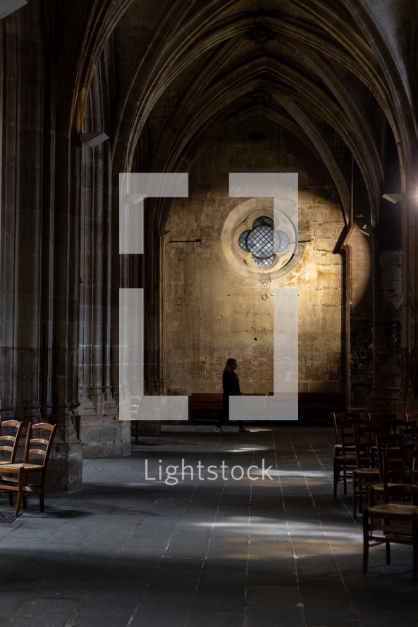 person walking in a cathedral 