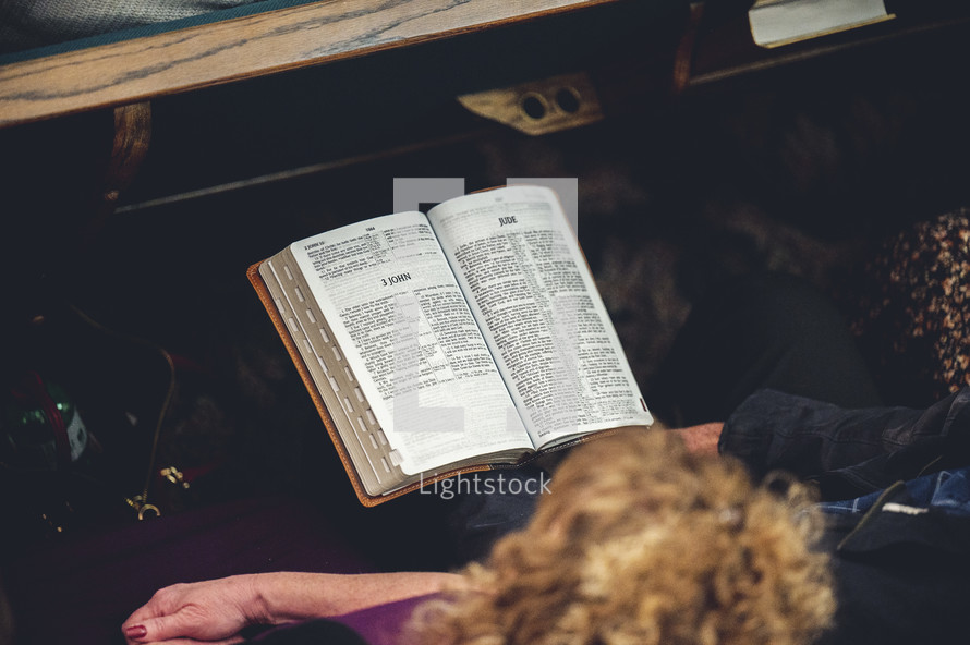 a man and woman reading a Bible at church 