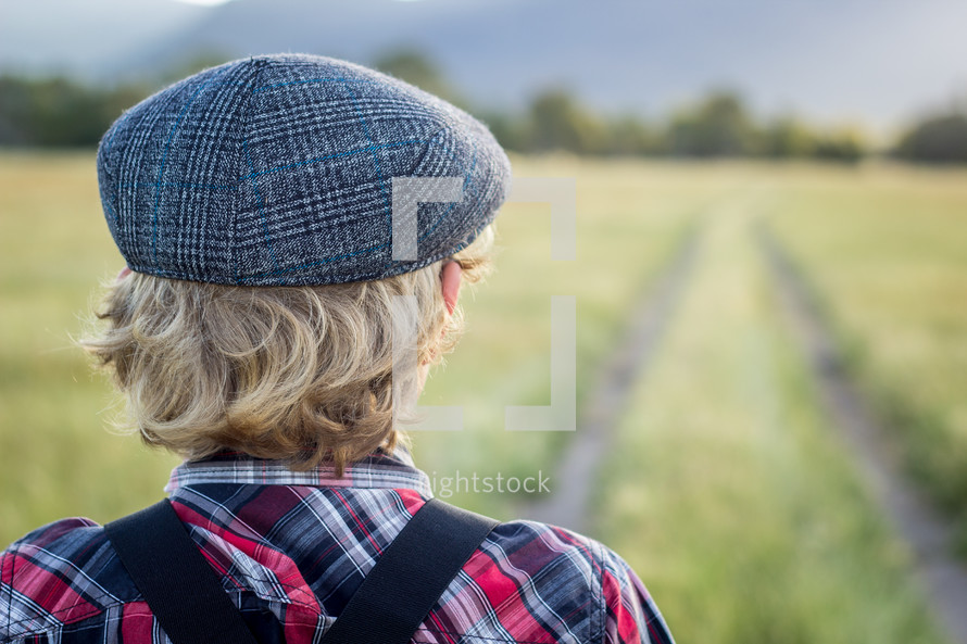 a boy standing in a field 
