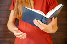 a girl singing from a Baptist Hymnal 