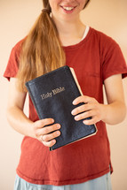 a teen girl holding a Bible 