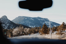 view of a mountain road through a windshield 