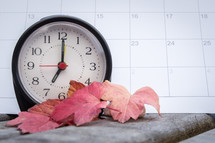 alarm clock and calendar with fall leaves 