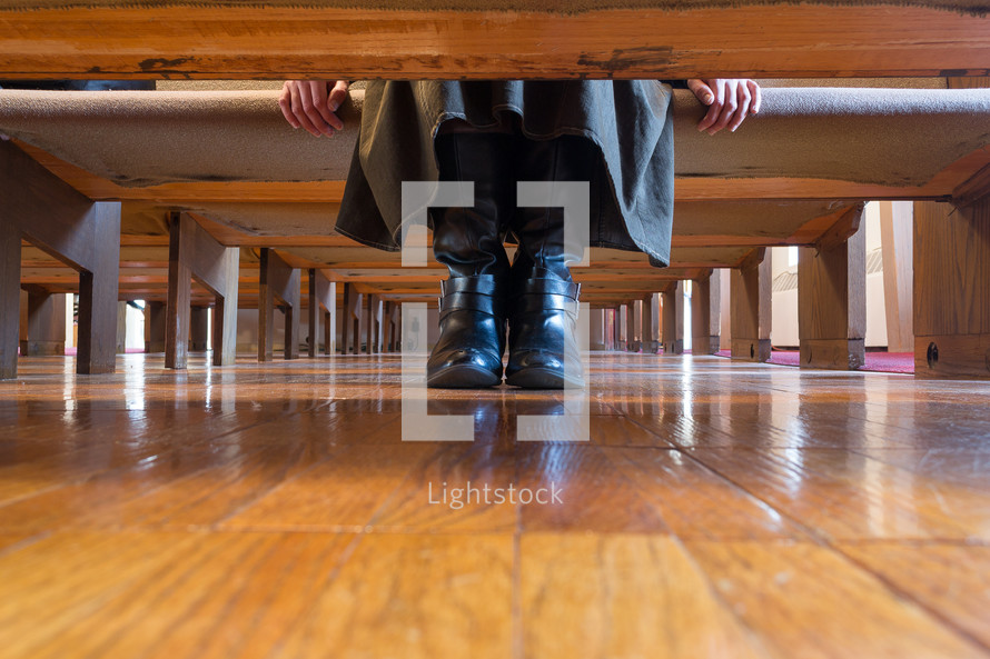 boots under a church pew 