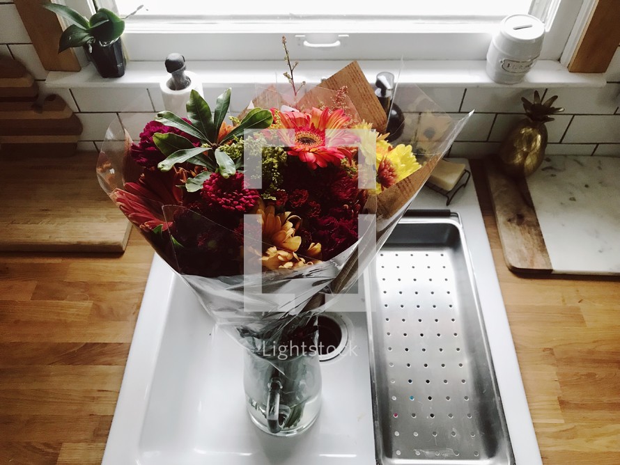 flower bouquet in a vase in a sink 