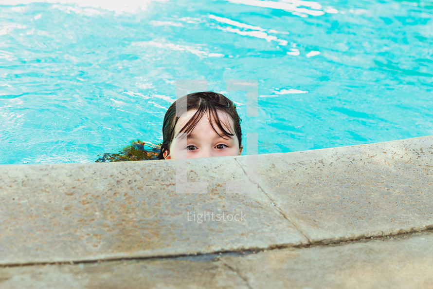 a girl at the edge of a pool 