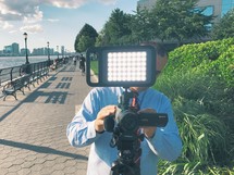 a man filming with a video camera 