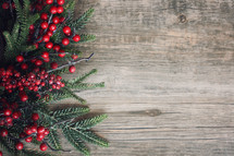 Festive Christmas Background with Evergreen Pine Branches and Red Winter Berries