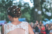 a bride walking down the aisle at an outdoor wedding 