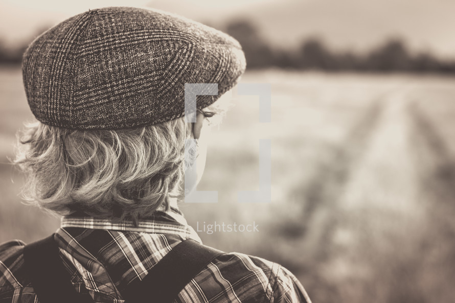 a young man looking out into a field 