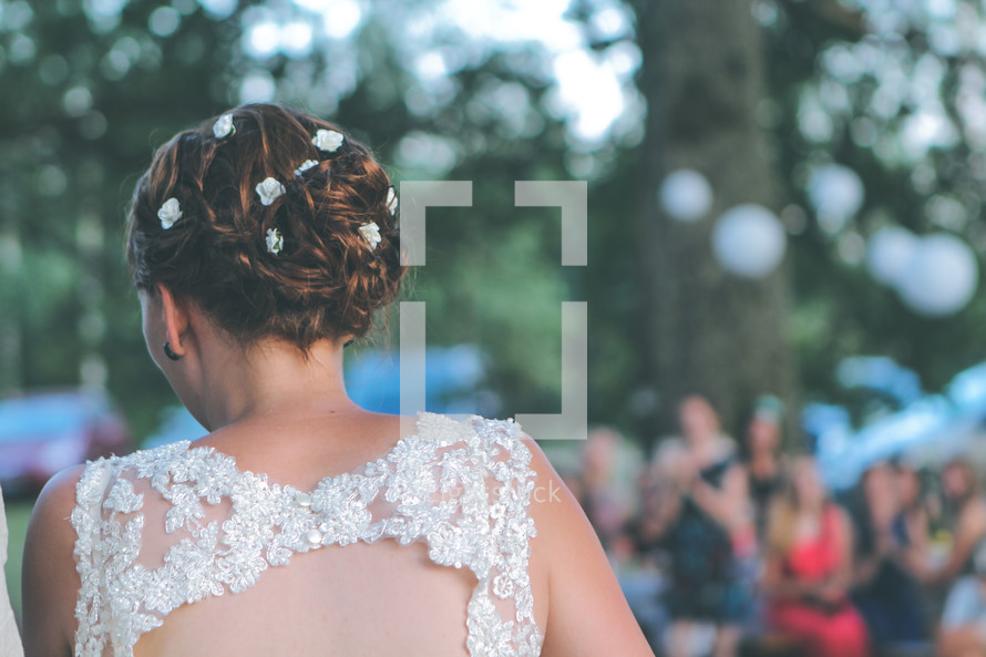a bride walking down the aisle at an outdoor wedding 